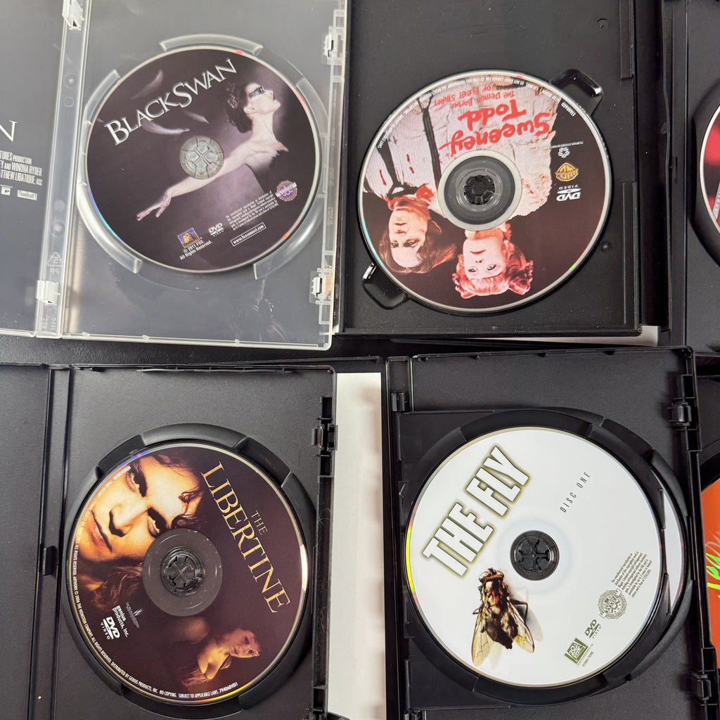 Set of 6 pre-owned DVD movie cases including Black Swan, David Cronenberg's The Fly, and Fear and Loathing in Las Vegas.