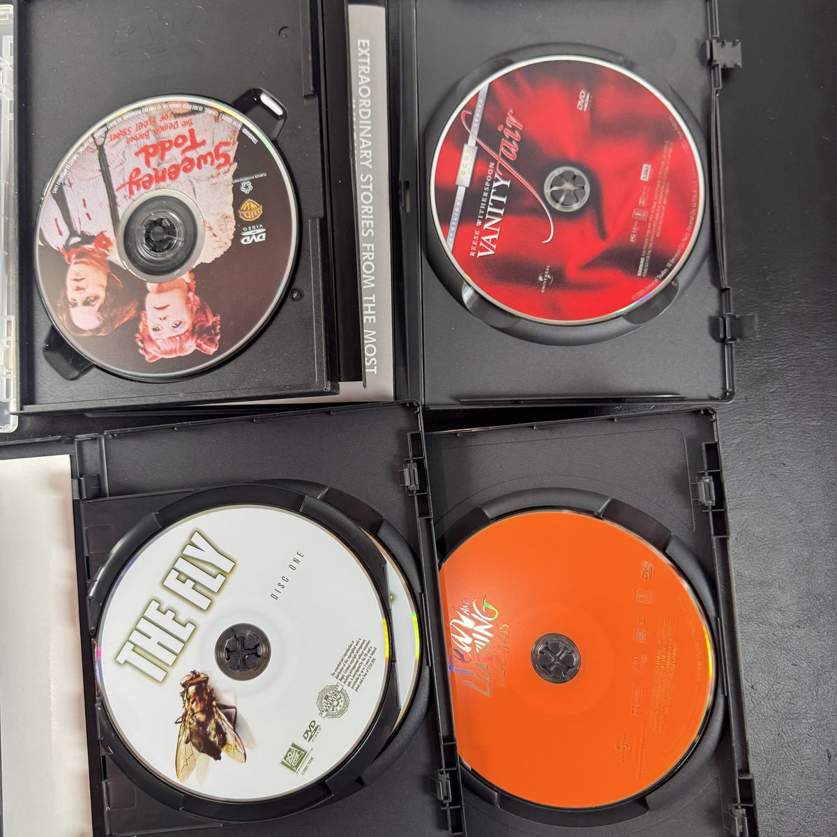 Set of 6 pre-owned DVD movie cases including Black Swan, David Cronenberg's The Fly, and Fear and Loathing in Las Vegas.