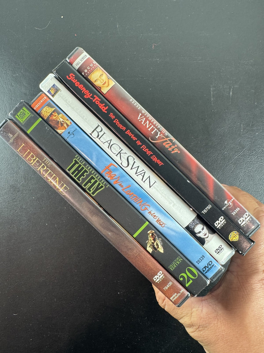Set of 6 pre-owned DVD movie cases including Black Swan, David Cronenberg's The Fly, and Fear and Loathing in Las Vegas.