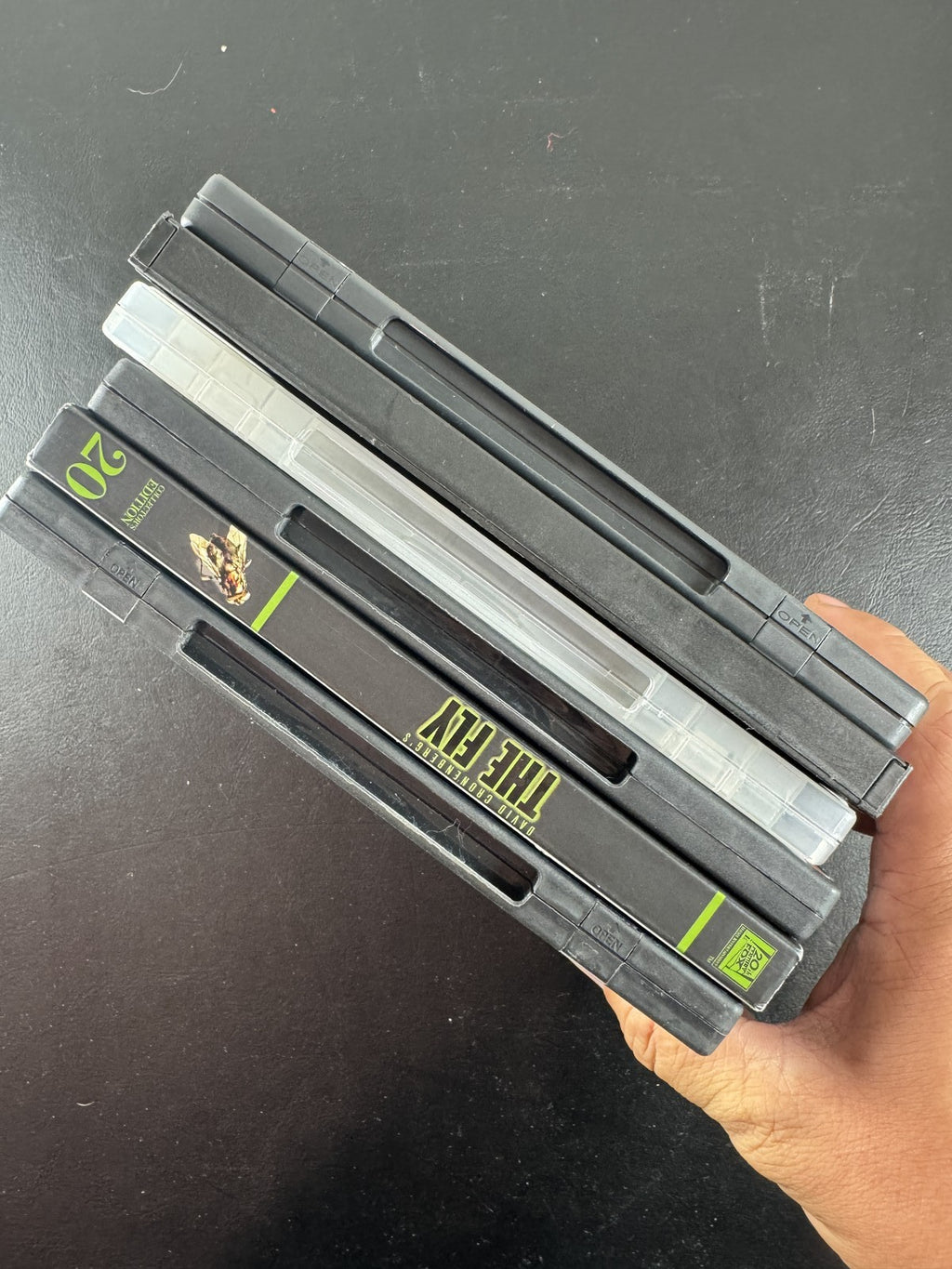Set of 6 pre-owned DVD movie cases including Black Swan, David Cronenberg's The Fly, and Fear and Loathing in Las Vegas.
