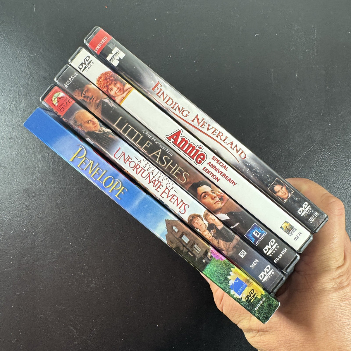 Collection of 5 pre-owned DVD movie cases including Finding Neverland, Annie, and A Series of Unfortunate Events.