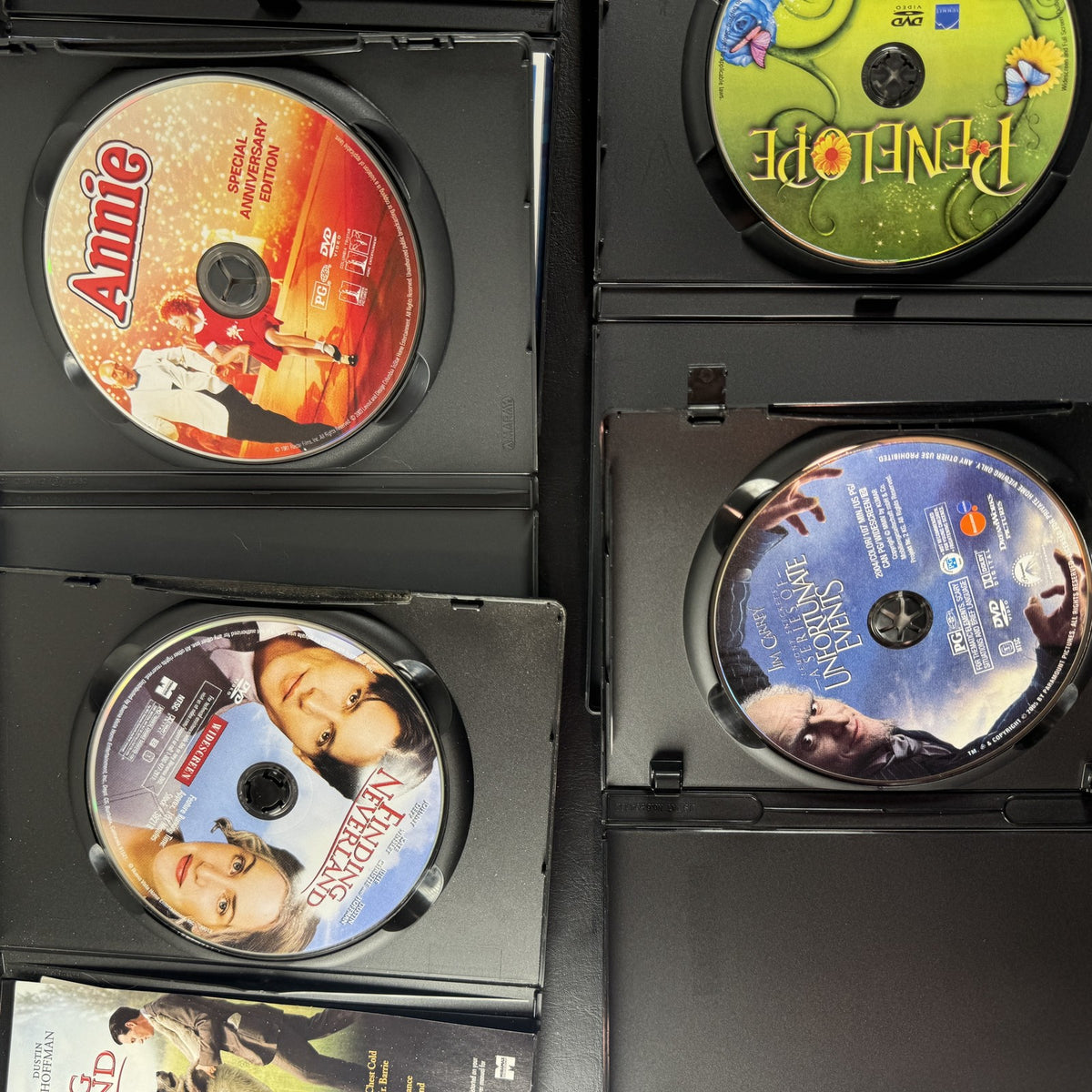 Collection of 5 pre-owned DVD movie cases including Finding Neverland, Annie, and A Series of Unfortunate Events.