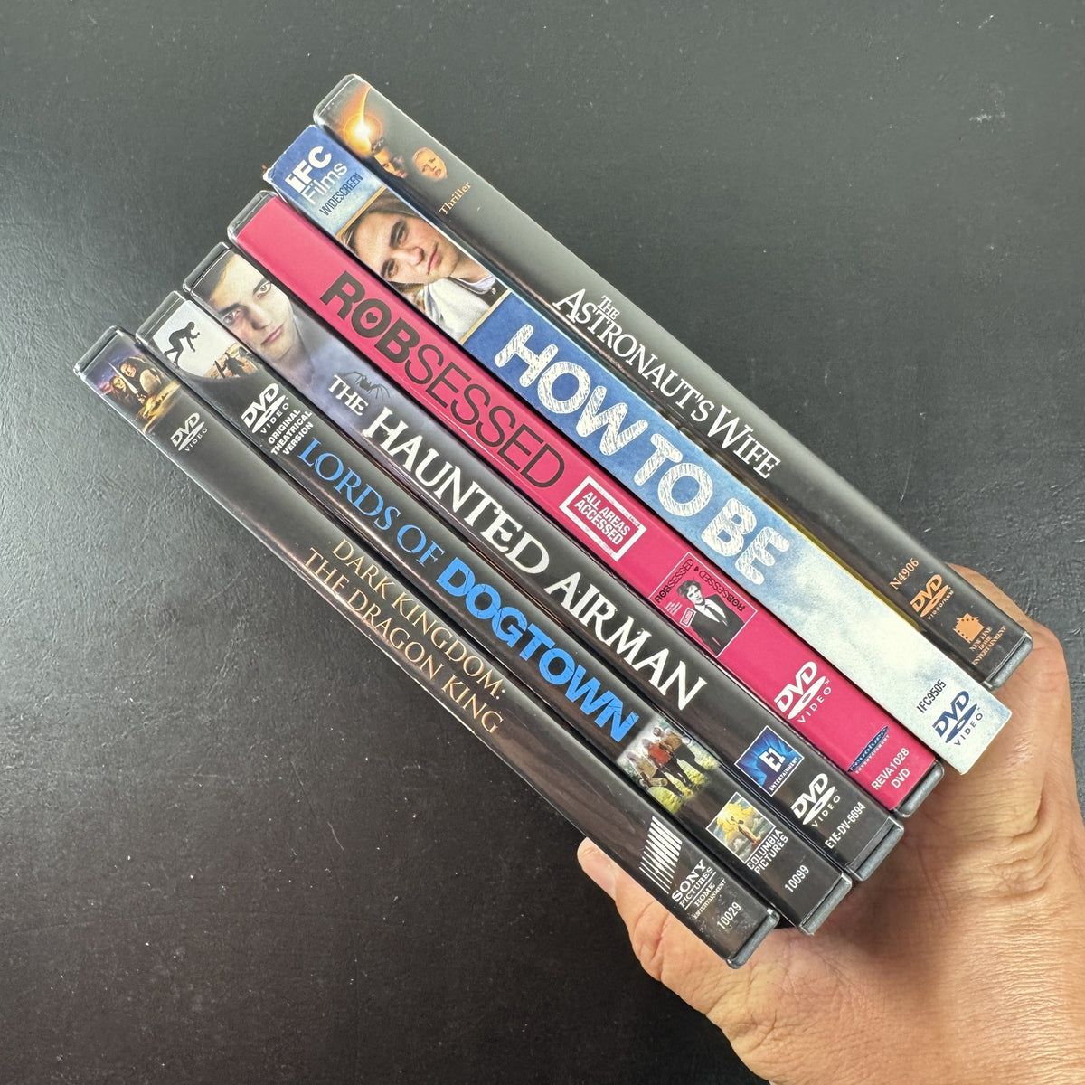 Collection of 6 DVD cases including Lords of Dogtown and Robert Pattinson movies.