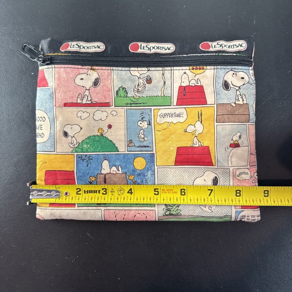 LeSportsac x Peanuts Snoopy vintage comic strip cosmetic pouch with top zip and black trim.