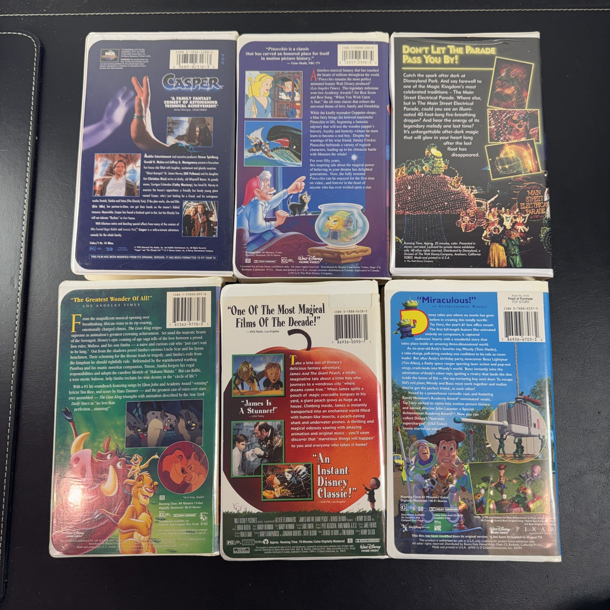 Set of 6 vintage Disney VHS tapes including Toy Story, Lion King, and Pinocchio in slipcases.