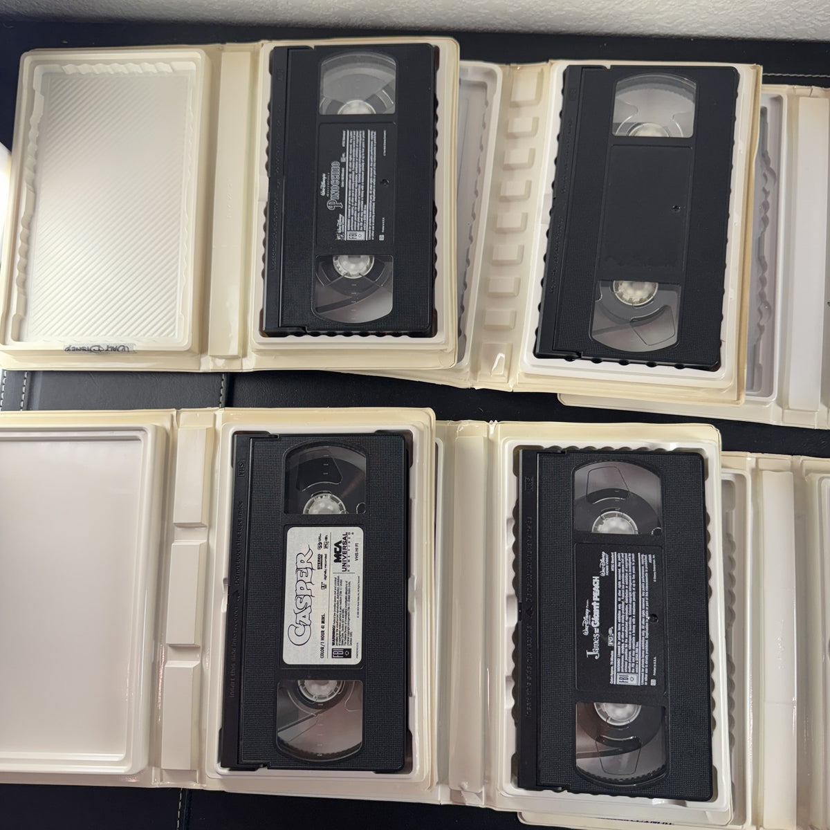 Set of 6 vintage Disney VHS tapes including Toy Story, Lion King, and Pinocchio in slipcases.