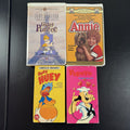 Bundle of 4 classic animated family movie VHS tapes including Annie, Gay Purr-ee, Popeye, and Baby Huey.