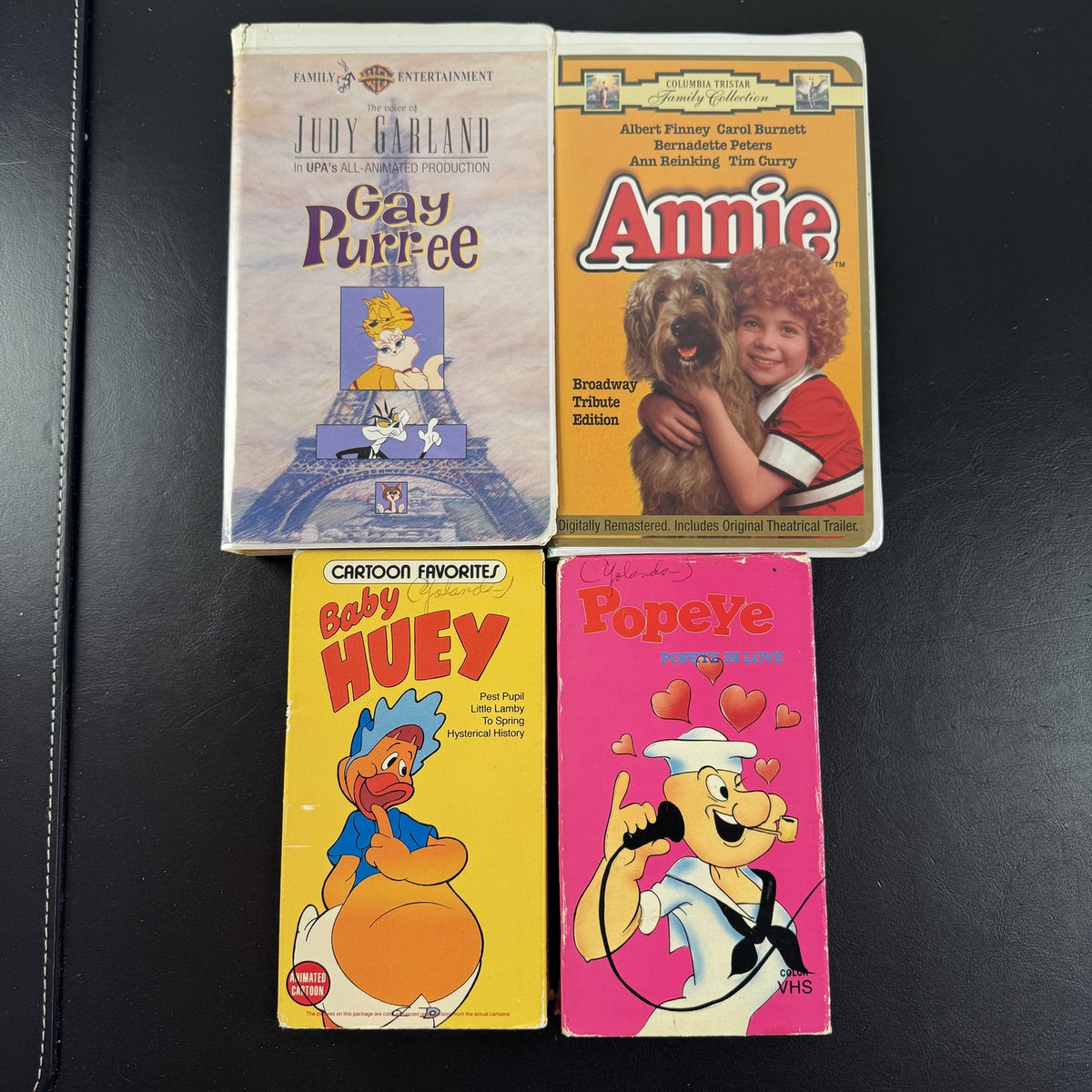 Bundle of 4 classic animated family movie VHS tapes including Annie, Gay Purr-ee, Popeye, and Baby Huey.