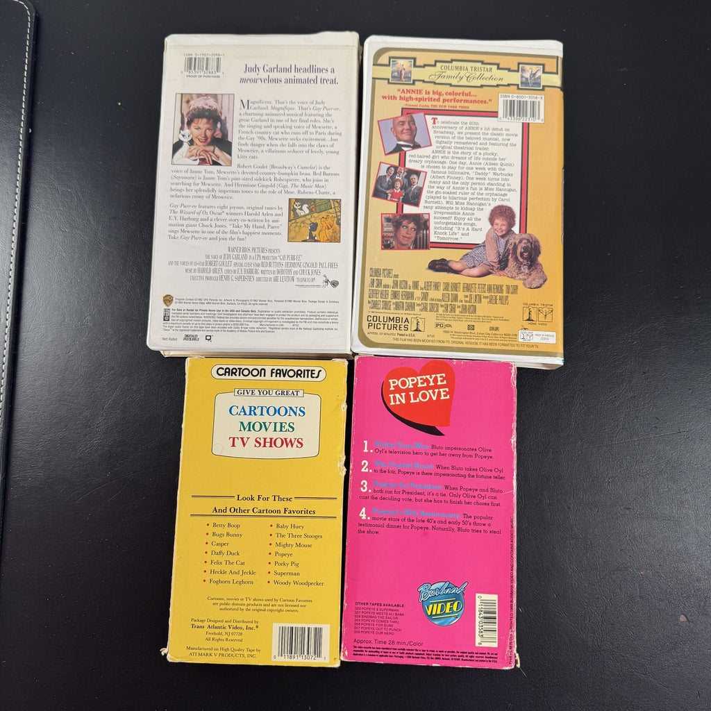 Bundle of 4 classic animated family movie VHS tapes including Annie, Gay Purr-ee, Popeye, and Baby Huey.