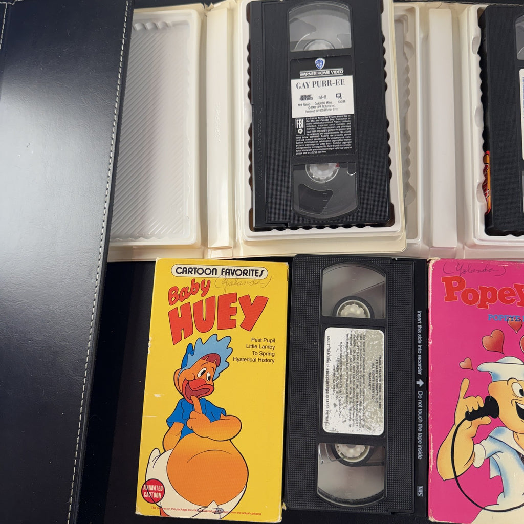 Bundle of 4 classic animated family movie VHS tapes including Annie, Gay Purr-ee, Popeye, and Baby Huey.