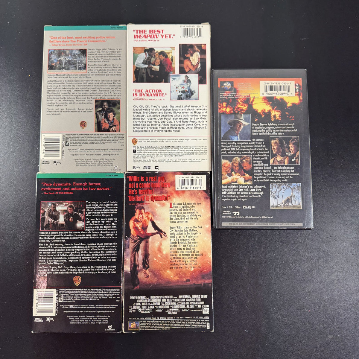 Lot of 5 classic action movie VHS tapes including Jurassic Park, Die Hard, and Lethal Weapon 1-3.