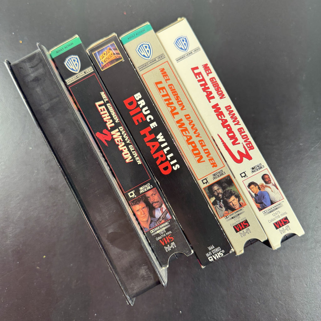 Lot of 5 classic action movie VHS tapes including Jurassic Park, Die Hard, and Lethal Weapon 1-3.