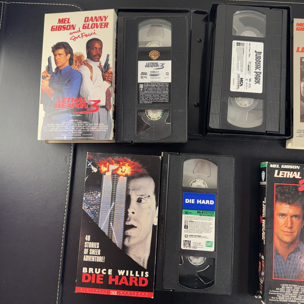 Lot of 5 classic action movie VHS tapes including Jurassic Park, Die Hard, and Lethal Weapon 1-3.