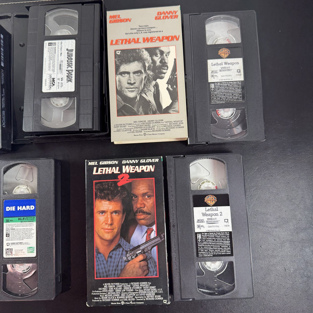 Lot of 5 classic action movie VHS tapes including Jurassic Park, Die Hard, and Lethal Weapon 1-3.