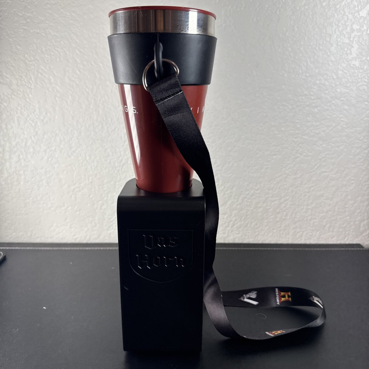 Red Das Horn Vikings History Channel promotional drinking horn with black display stand and lanyard.