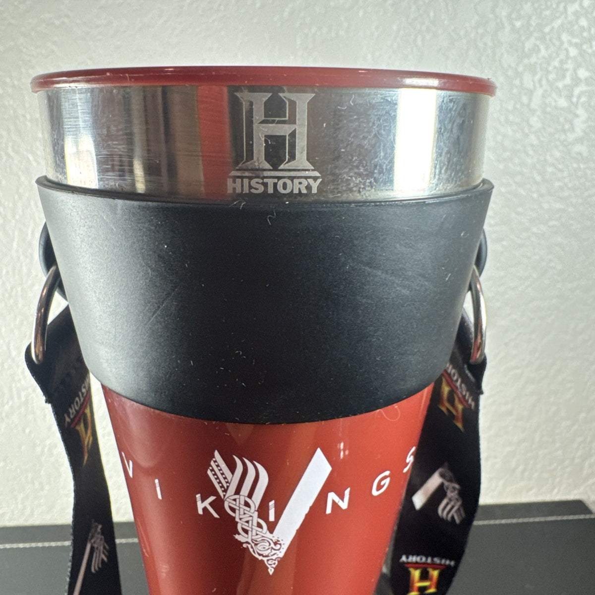 Red Das Horn Vikings History Channel promotional drinking horn with black display stand and lanyard.
