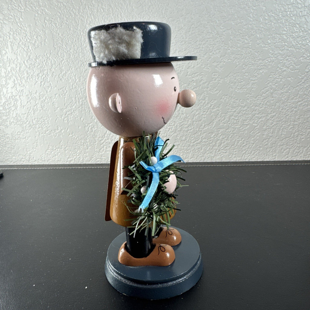 8-inch wooden Peanuts holiday nutcracker holding a Christmas wreath
