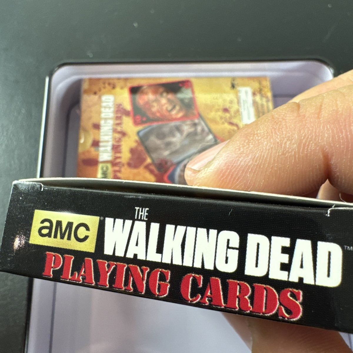 The Walking Dead playing card set with two decks and metal tin by Cardinal featuring Daryl and Merle Dixon.