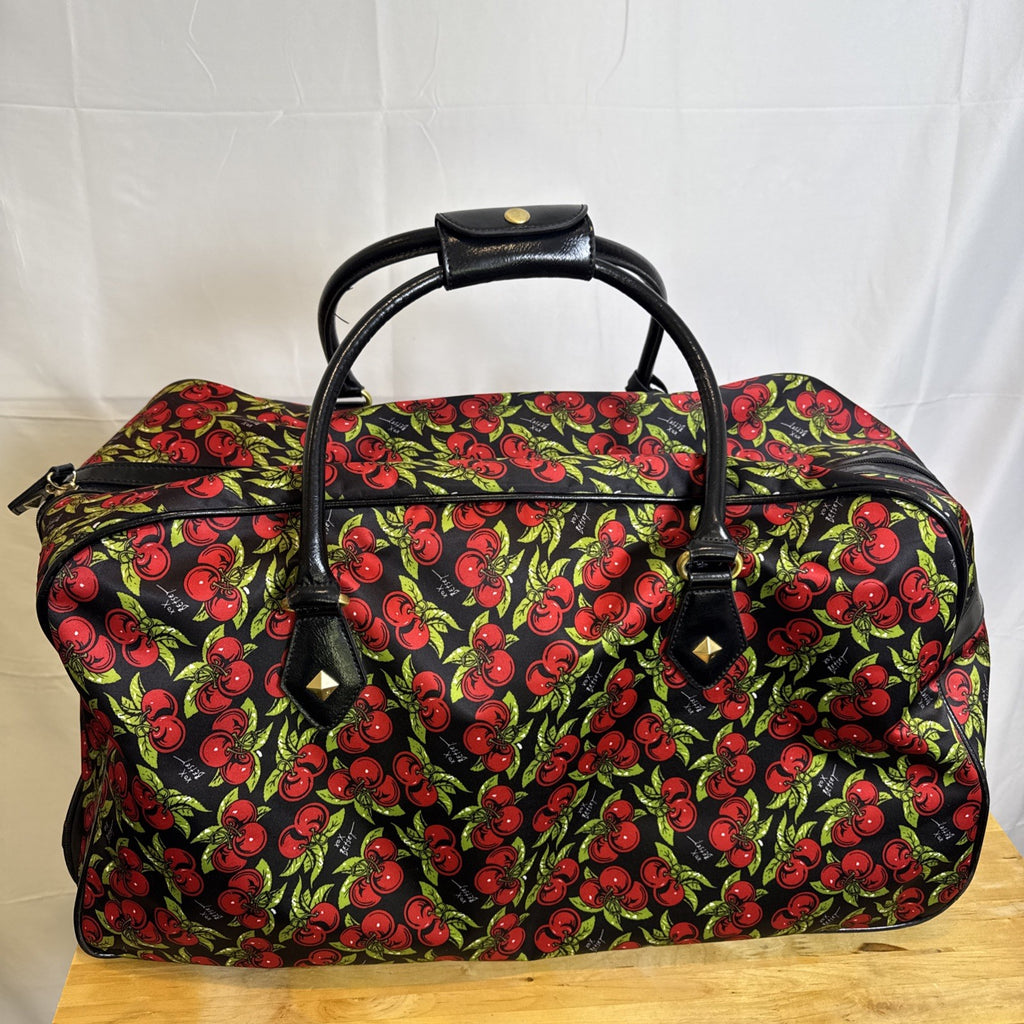 Betsey Johnson black rolling weekender duffel bag featuring a red cherry print and telescoping handle.