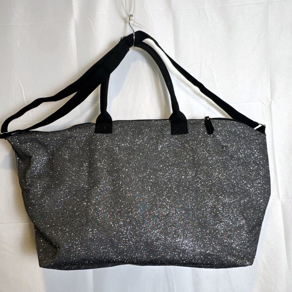 Victoria's Secret oversized silver glitter weekender tote bag with London New York Paris graphic and black canvas handles.