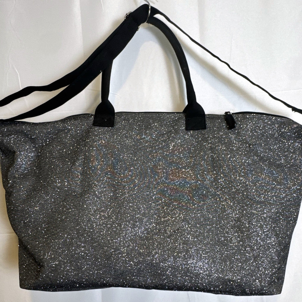 Victoria's Secret oversized silver glitter weekender tote bag with London New York Paris graphic and black canvas handles.