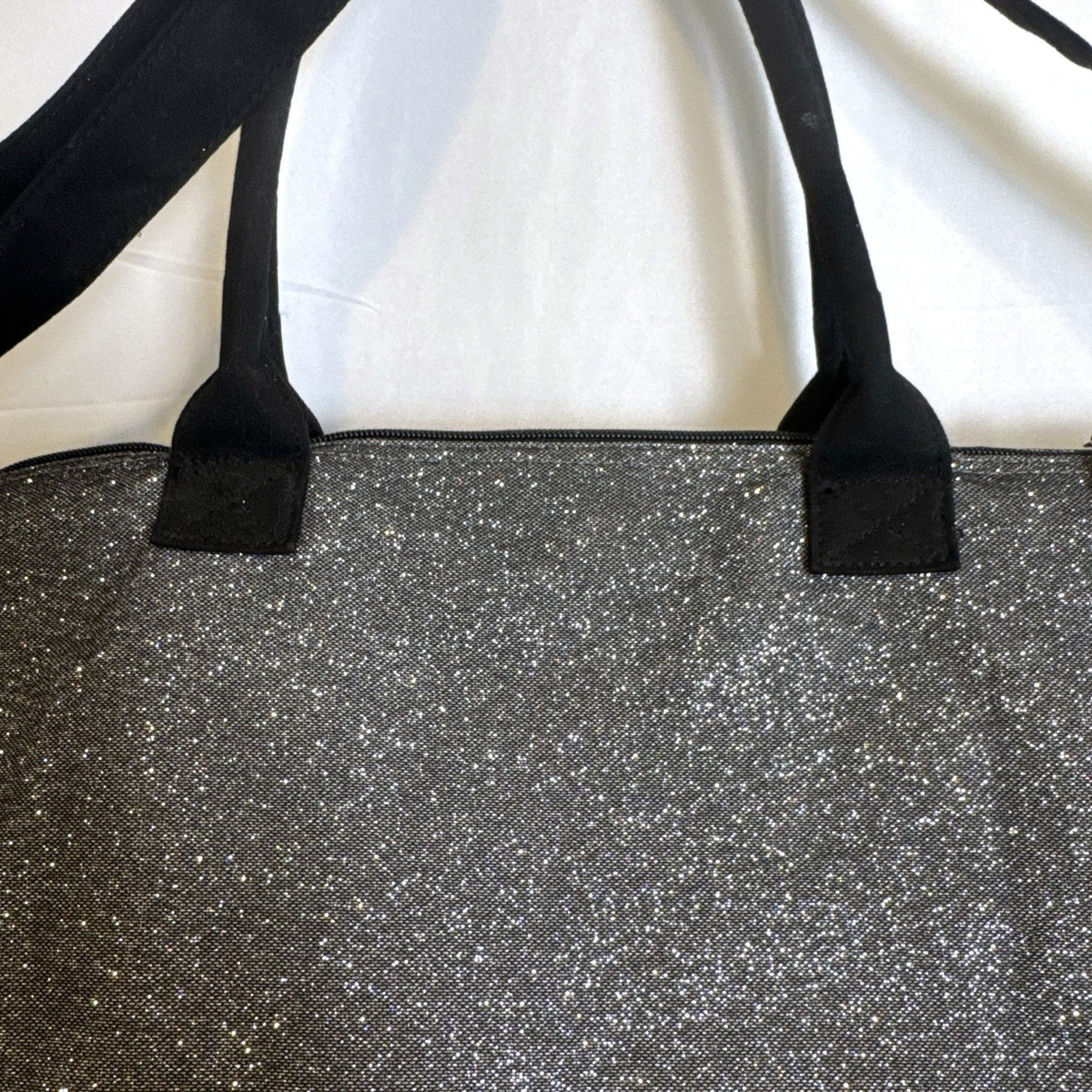 Victoria's Secret oversized silver glitter weekender tote bag with London New York Paris graphic and black canvas handles.