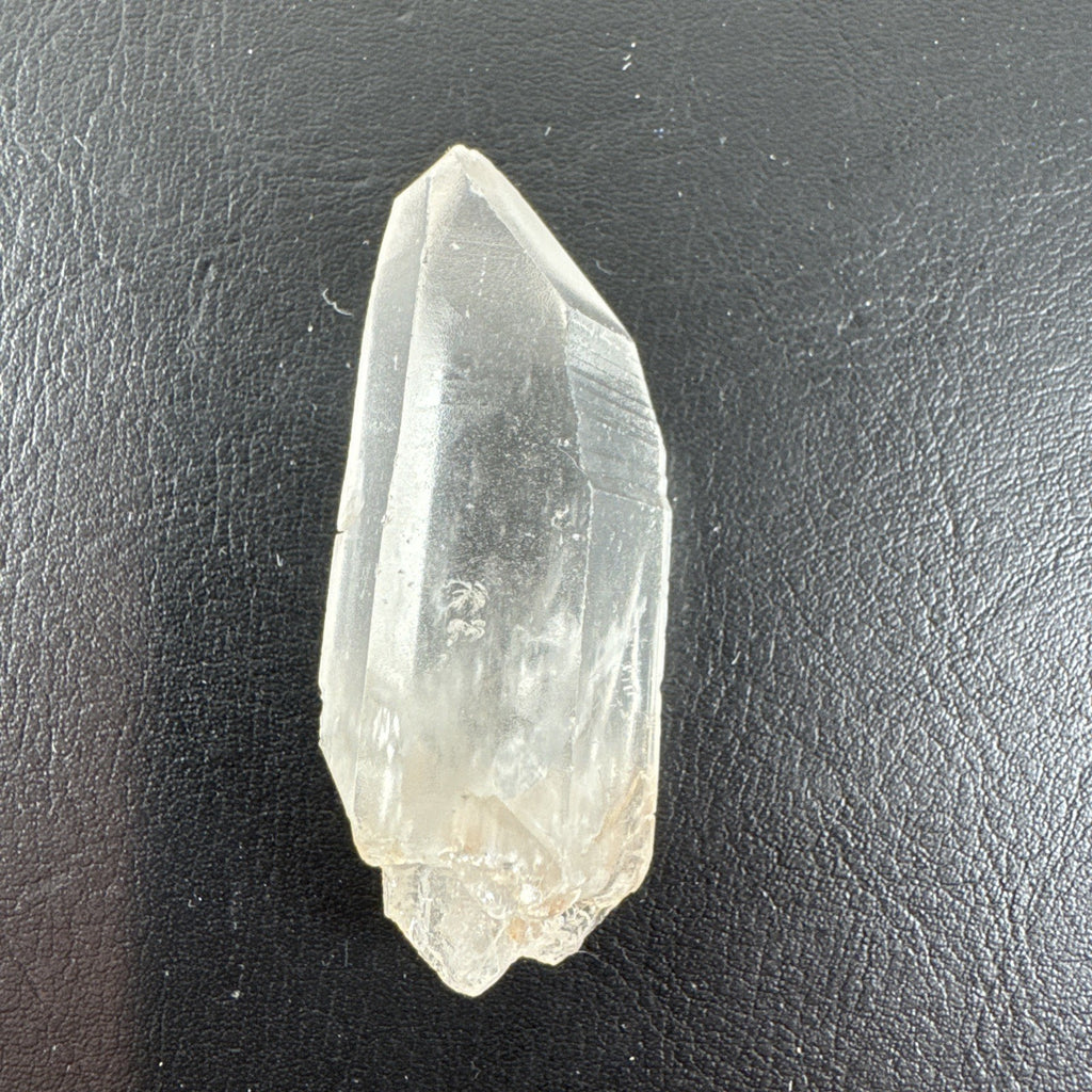 Raw Brazilian Lemurian clear quartz crystal point weighing 24.3g with natural horizontal striations and silver gift box