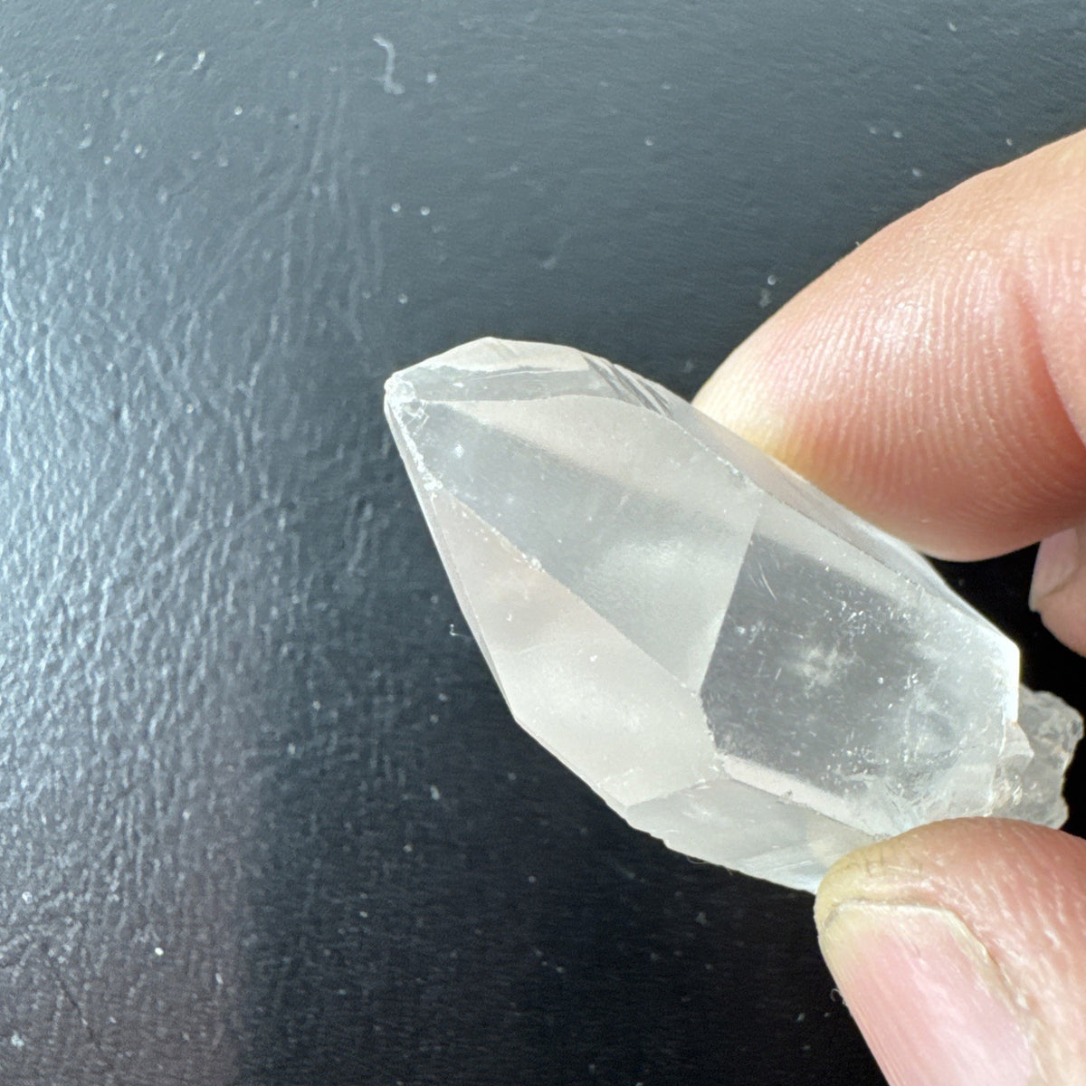 Raw Brazilian Lemurian clear quartz crystal point weighing 24.3g with natural horizontal striations and silver gift box