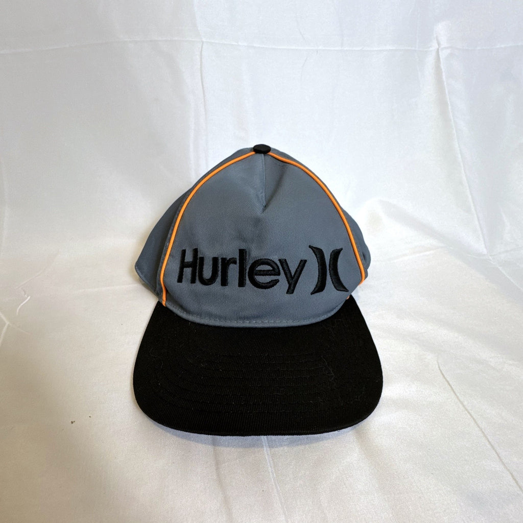 Set of 3 snapback hats including a grey Hurley youth cap, black H&M faux leather hat, and navy blue ROMA cap.