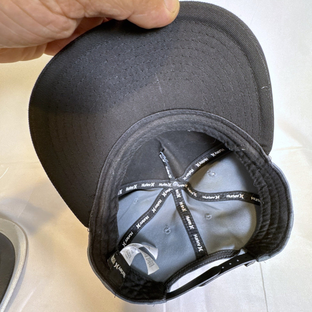 Set of 3 snapback hats including a grey Hurley youth cap, black H&M faux leather hat, and navy blue ROMA cap.
