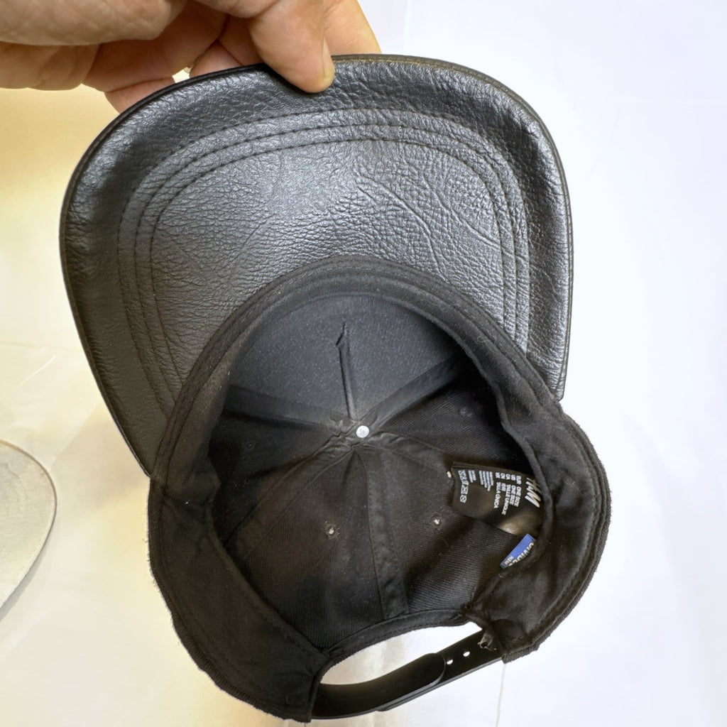 Set of 3 snapback hats including a grey Hurley youth cap, black H&M faux leather hat, and navy blue ROMA cap.