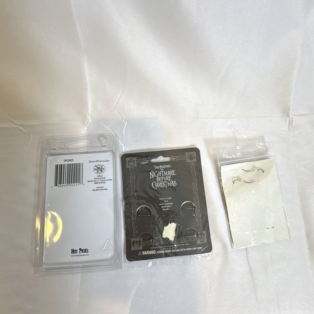 Sealed Disney and Tim Burton accessory set featuring Nightmare Before Christmas pins, Scissorhands earrings, and picks