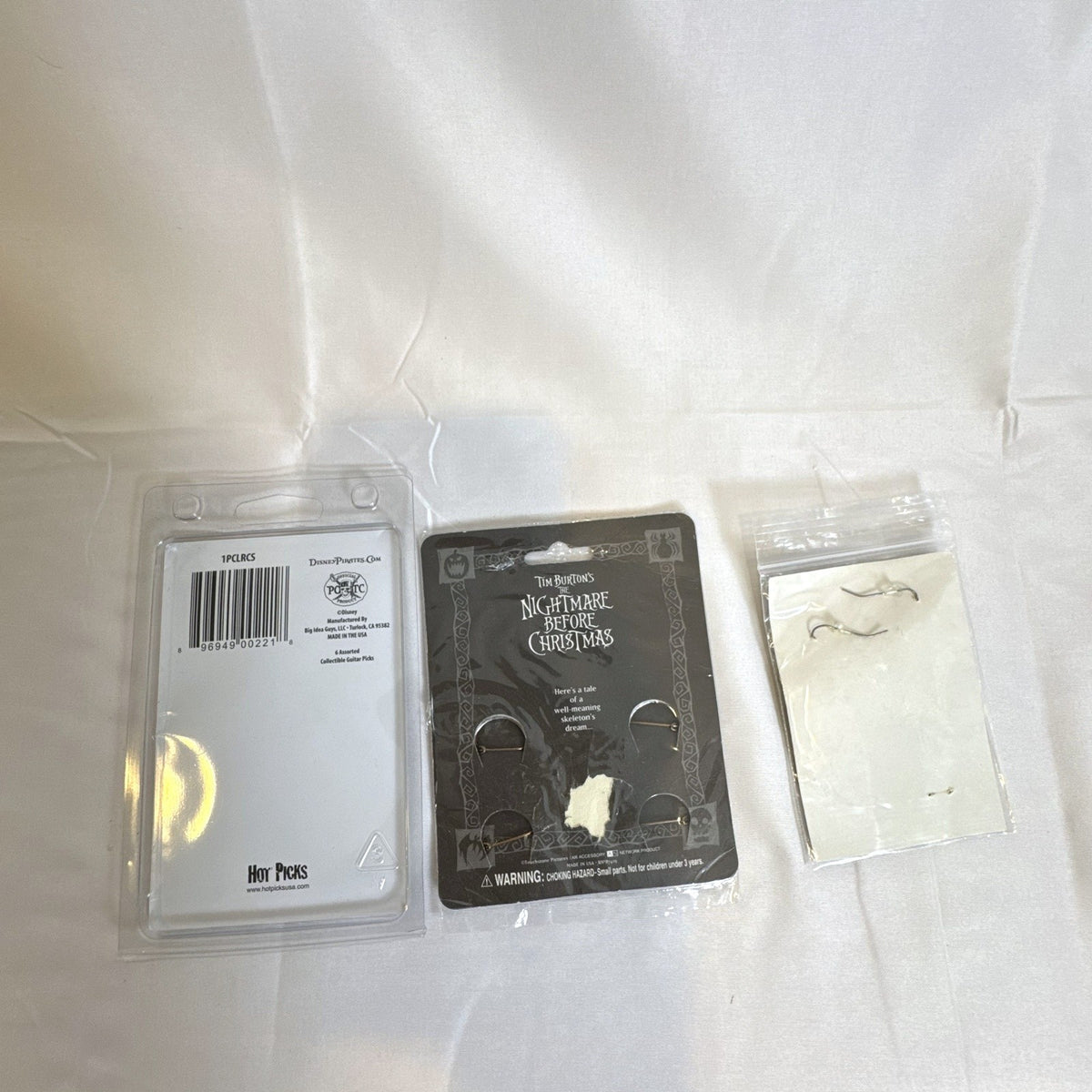 Sealed Disney and Tim Burton accessory set featuring Nightmare Before Christmas pins, Scissorhands earrings, and picks