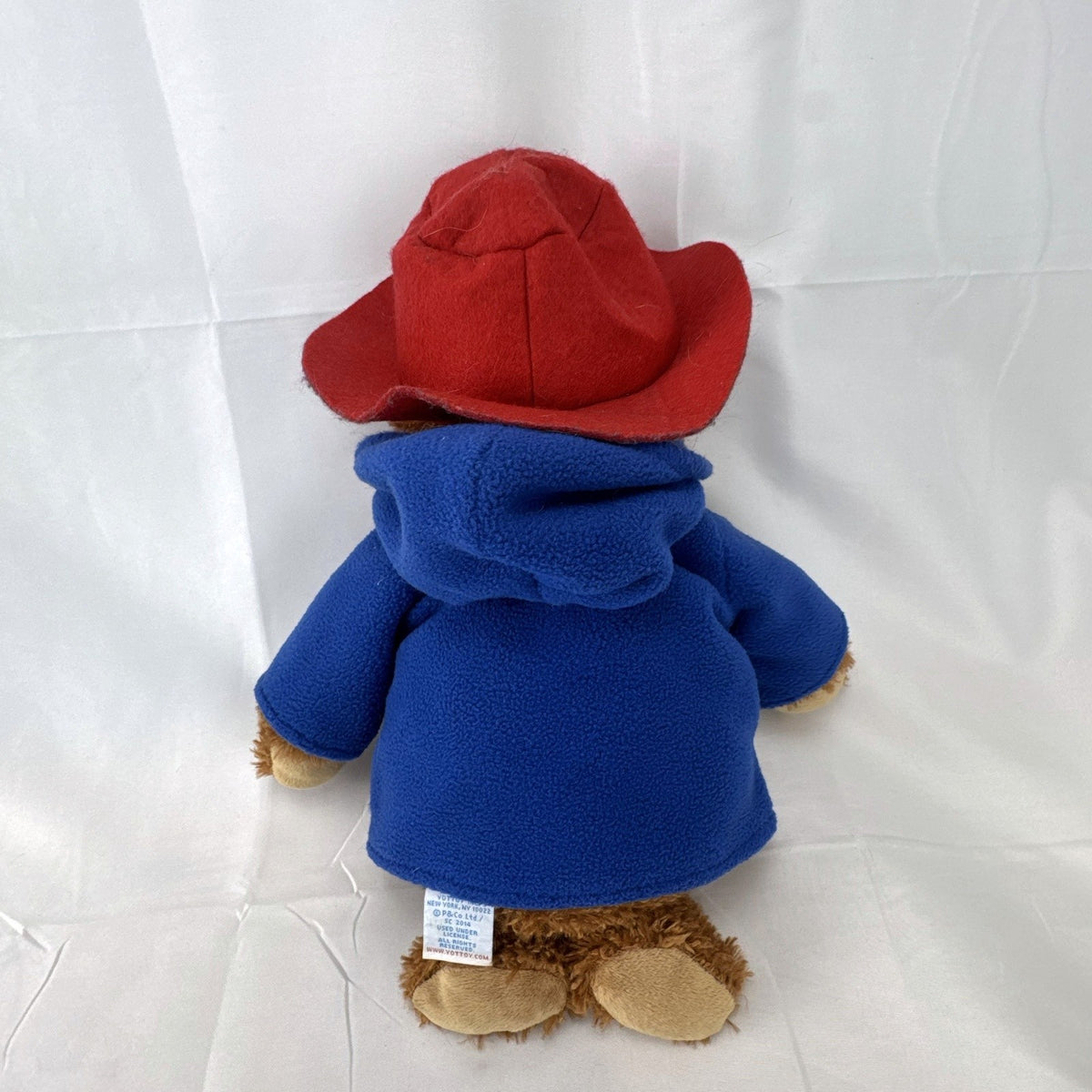 2014 Yottoy 11-inch Paddington Bear plush with blue fleece duffle coat, red hat, and Macy's luggage tag