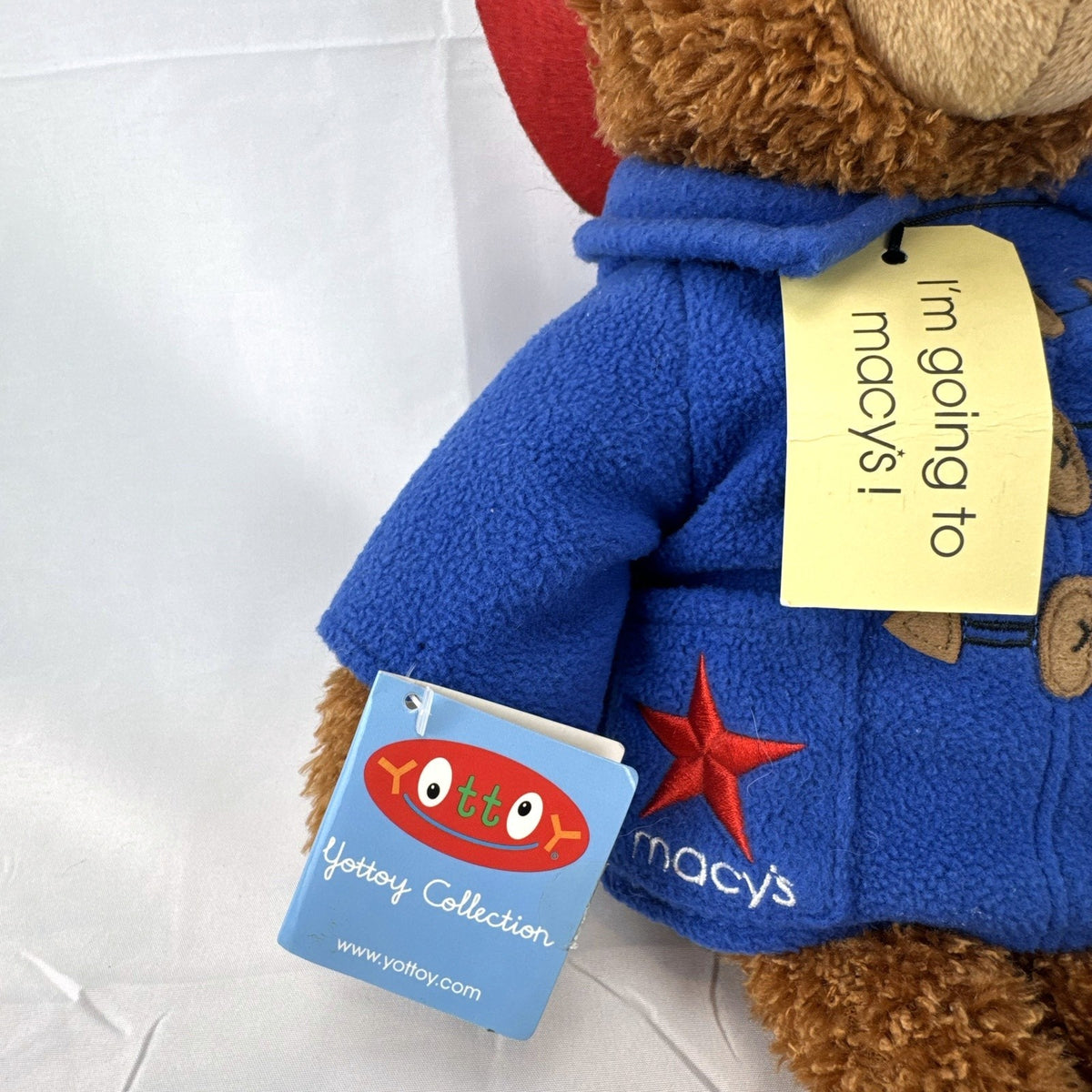 2014 Yottoy 11-inch Paddington Bear plush with blue fleece duffle coat, red hat, and Macy's luggage tag
