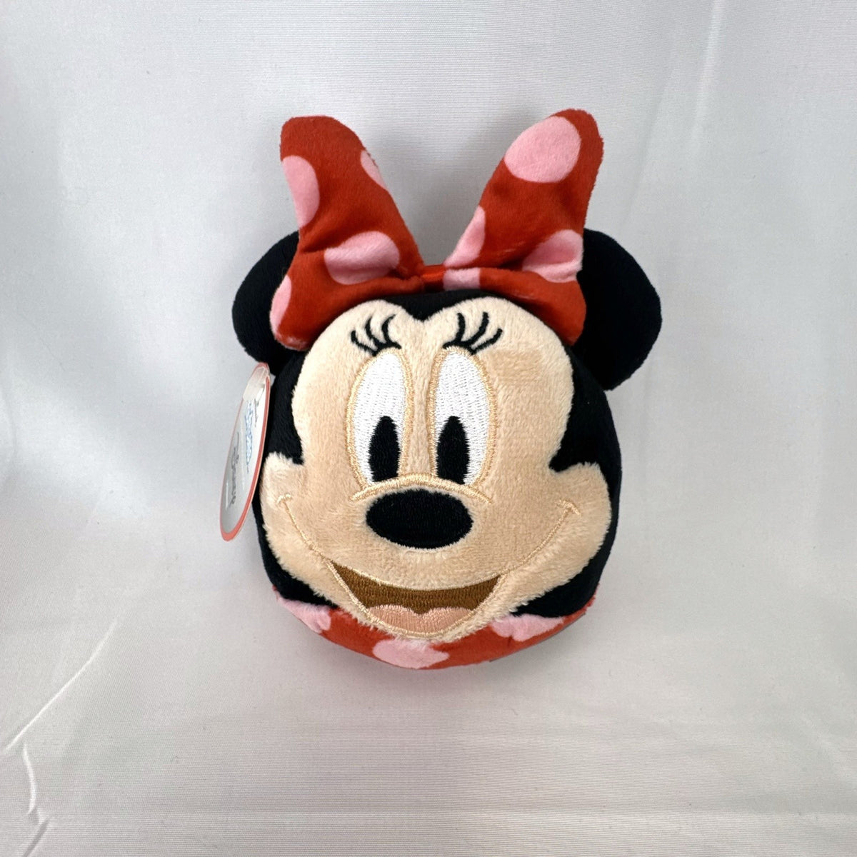 Hallmark Fluffballs Disney Minnie Mouse 4 inch plush ornament with red polka dot bow and new tags attached.