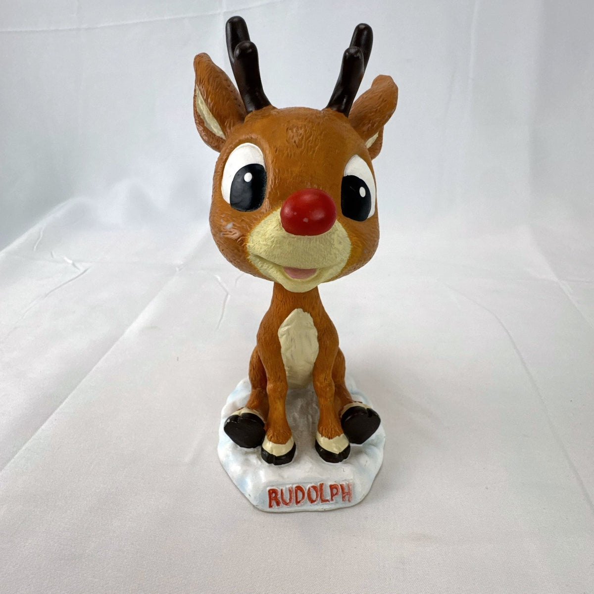 BD&A 6 inch painted ceramic Rudolph the Red-Nosed Reindeer bobblehead holiday figurine.