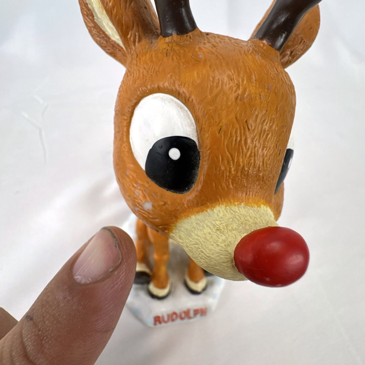 BD&A 6 inch painted ceramic Rudolph the Red-Nosed Reindeer bobblehead holiday figurine.