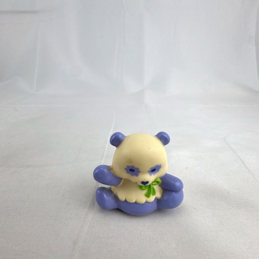 Vintage miniature purple and cream PVC vinyl panda bear figurine with green bow and flower-shaped eyes
