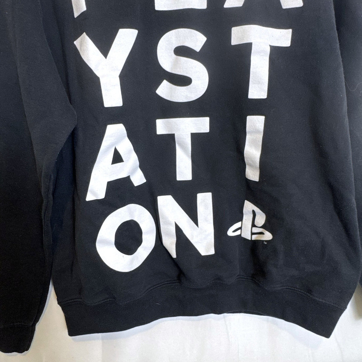 Ripple Junction PlayStation stacked text logo crewneck sweatshirt in black, men's size medium.