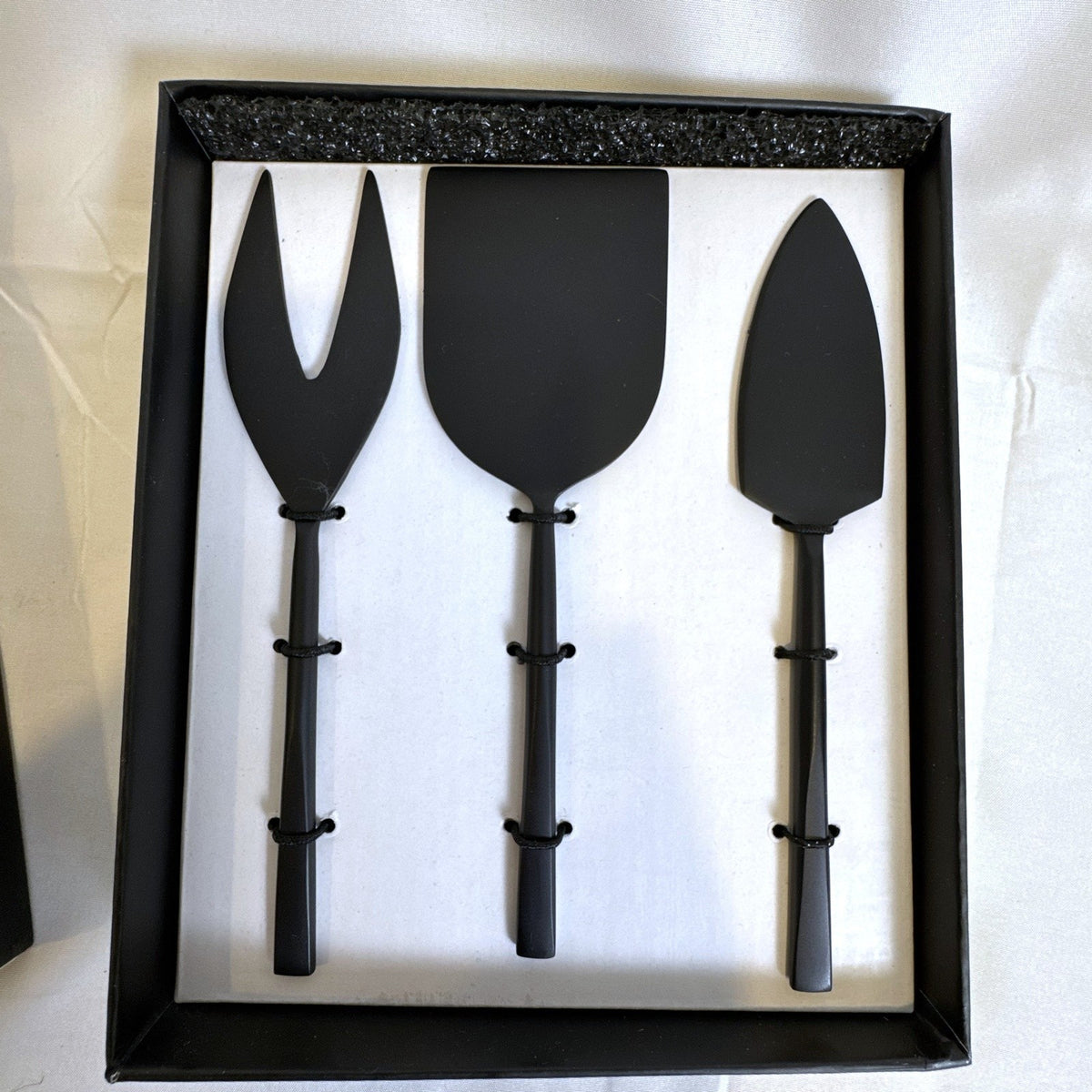 Crate and Barrel matte black stainless steel cheese knife set for charcuterie serving