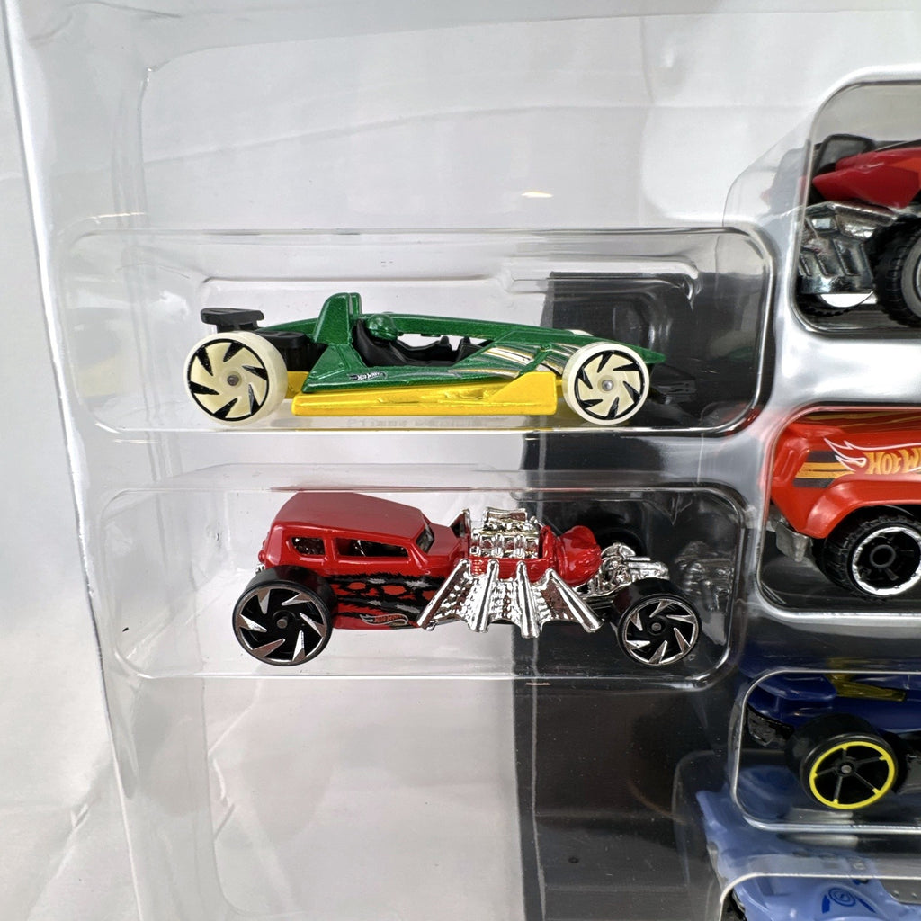 Hot Wheels 1:64 scale diecast 9-car gift set featuring exclusive metallic green Le Mans racer and off-road buggies.