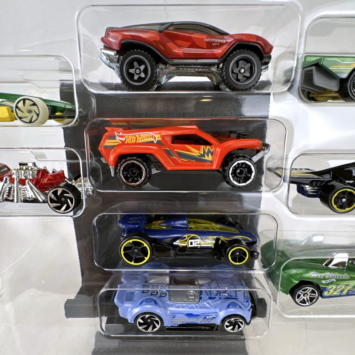 Hot Wheels 1:64 scale diecast 9-car gift set featuring exclusive metallic green Le Mans racer and off-road buggies.