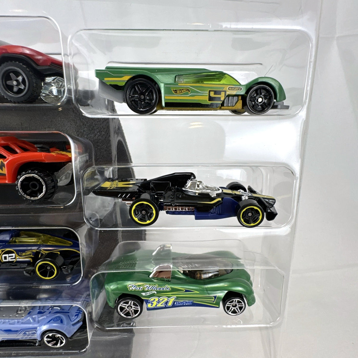 Hot Wheels 1:64 scale diecast 9-car gift set featuring exclusive metallic green Le Mans racer and off-road buggies.