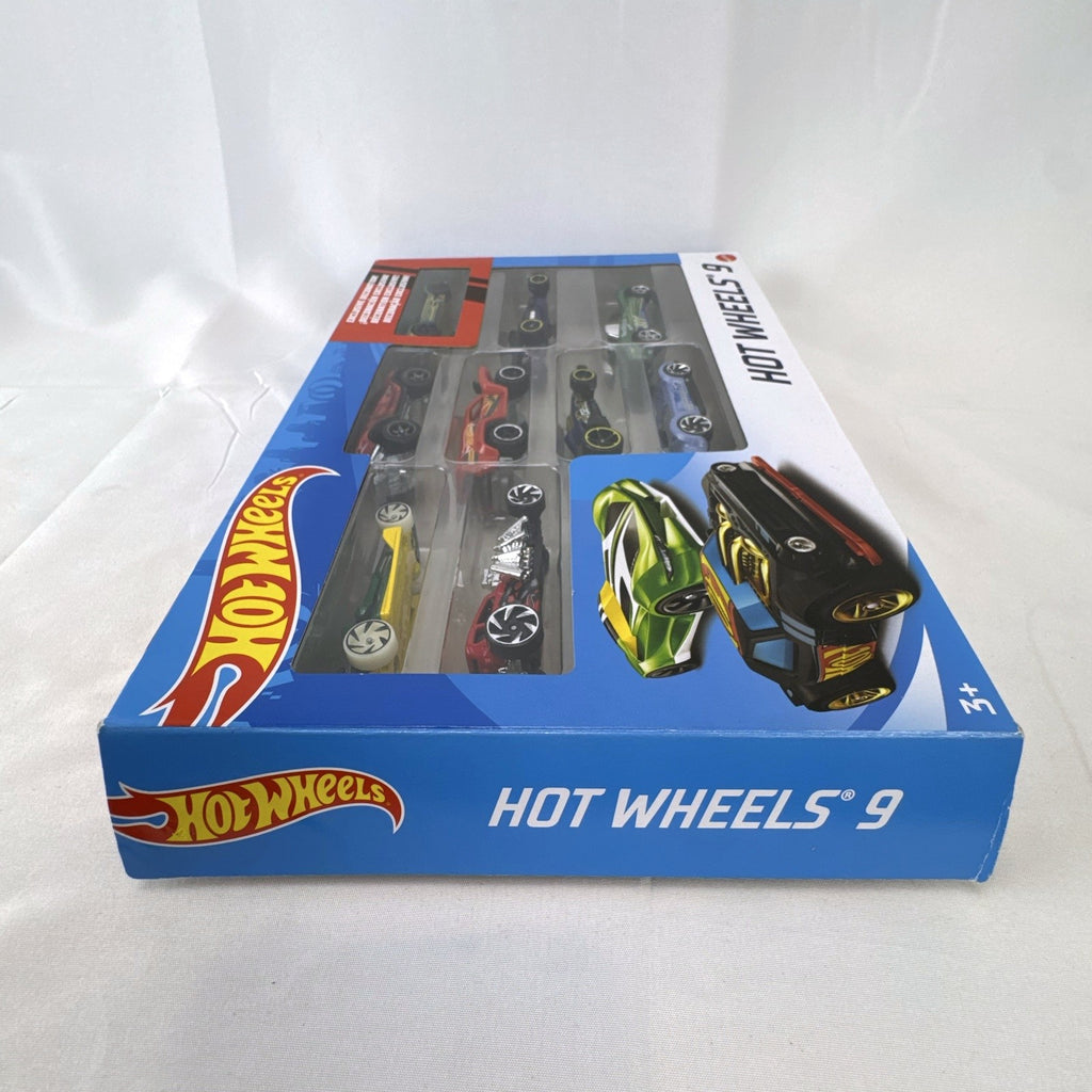 Hot Wheels 1:64 scale diecast 9-car gift set featuring exclusive metallic green Le Mans racer and off-road buggies.