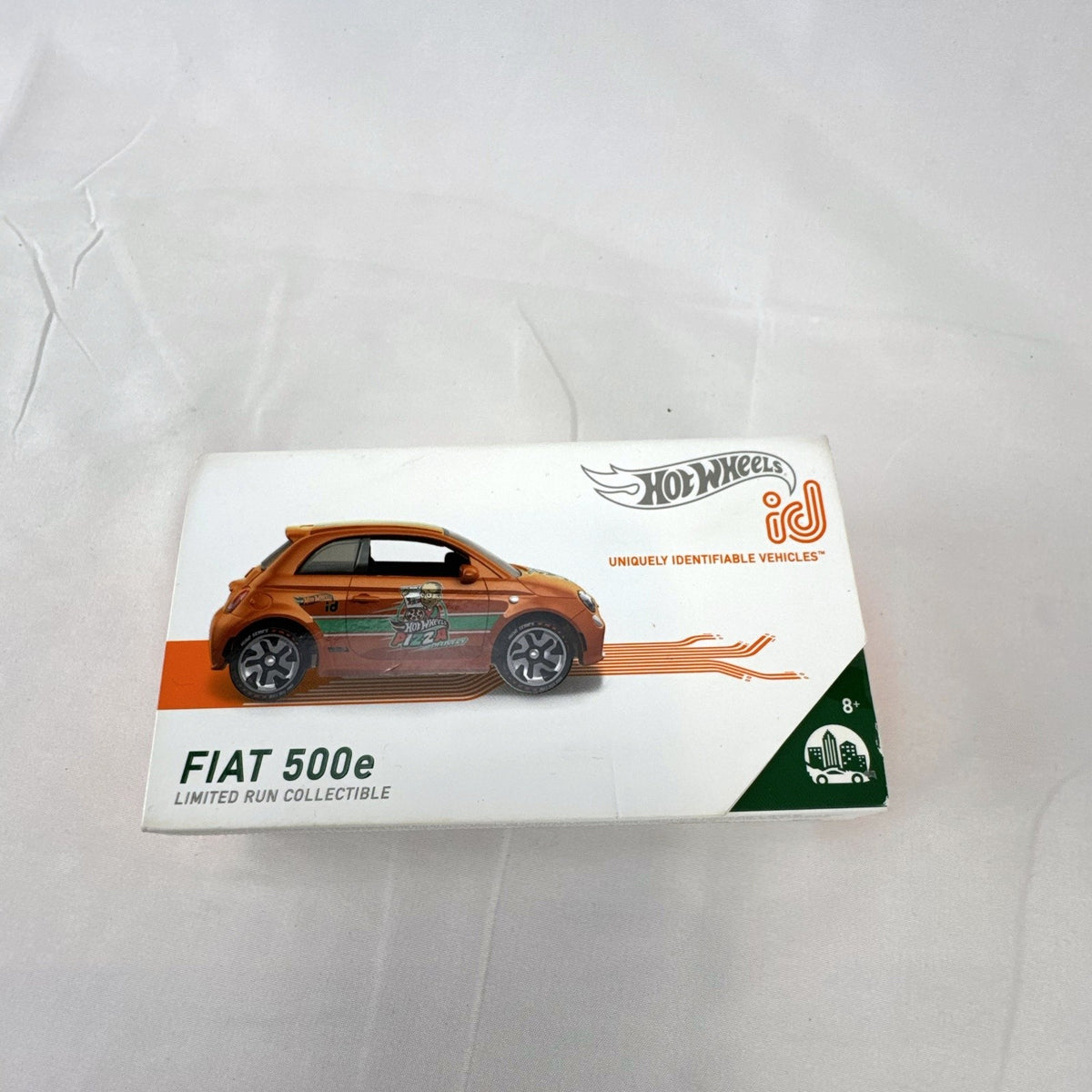 Hot Wheels id 1:64 scale Fiat 500e diecast car in metallic orange pizza delivery livery