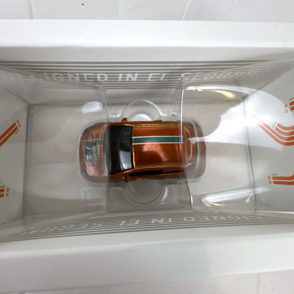 Hot Wheels id 1:64 scale Fiat 500e diecast car in metallic orange pizza delivery livery