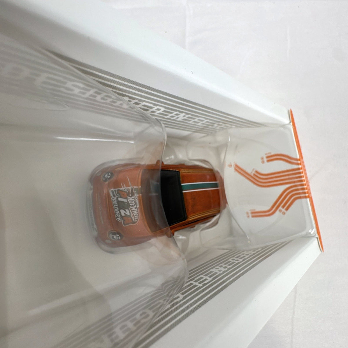 Hot Wheels id 1:64 scale Fiat 500e diecast car in metallic orange pizza delivery livery