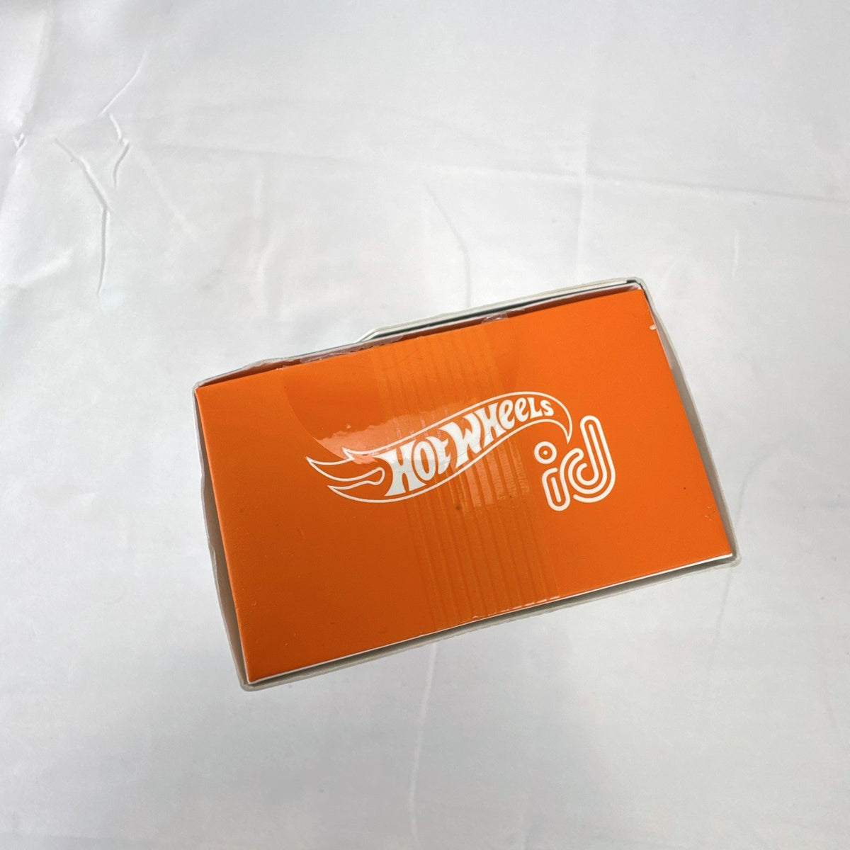 Hot Wheels id 1:64 scale Fiat 500e diecast car in metallic orange pizza delivery livery