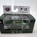 M2 Machines 1:64 scale 1969 Pontiac GTO diecast car in green, factory sealed in acrylic display case